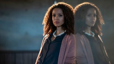 Gugu Mbatha-Raw plays Jane in The Girl Before. She wears a pink cardigan, grey top and a peal-like necklace.