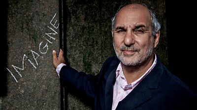Image of Alan Yentob with his hand on a wall that has Imagine written in chalk on it