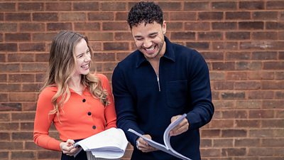 Adam Thomas and Katie Griffiths laugh as they pose with their Waterloo Road scripts