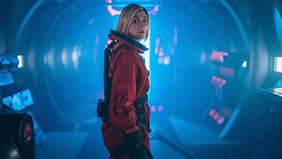 Jodie Whittaker's Doctor wears a space suit, without its helmet
