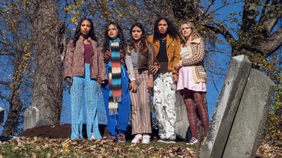 Left to right: Zaria, Malia Pyles, Maia Reficco, Chandler Kinney and Bailee Madison stand in a graveyard holding hands and looking distressed