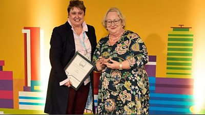 Local Democracy Reporter of the Year Tanya Fowles, left, receives her award from Jackie Weaver