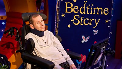 Rob Burrow sits in his wheelchair on the CBeebies Bedtime Stories set