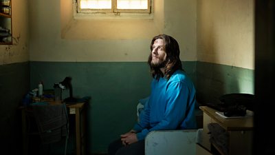 Tommy (James Norton) sits in his prison cell, looking up towards the ceiling