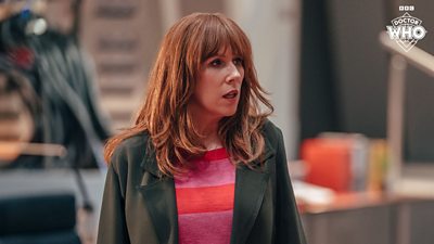 Catherine Tate as Donna Noble in Doctor Who's 60th Anniversary special - she stands indoors looking concerned