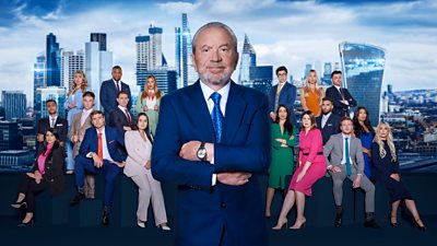 Lord Sugar stands in front of all the candidates taking part in The Apprentice 2023. They sit in groups against a backdrop of skyscrapers in The City of London