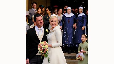 Trixie (Helen George) and Matthew (Olly Rix) grin outside the church as the nuns and their friends look on, smiling