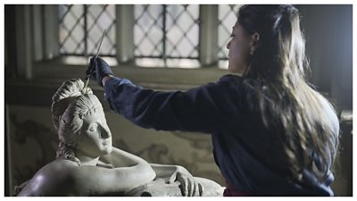 Conservator Ana works on the statue of La Baccelli, who seems to gaze up at her