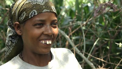 A woman in a headscarf looks happy