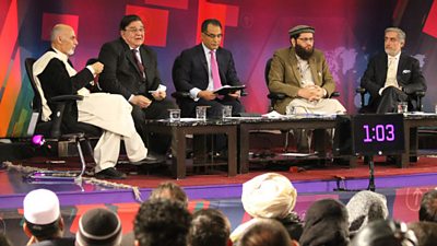 A panel of five politicians on the stage, including then-president Hamid Karzai. 