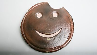 A brown circle with a smiley face.