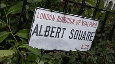 Albert Square sign attached to iron railings 