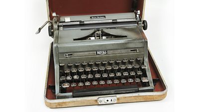 A well-used typewriter in a travelling case. 