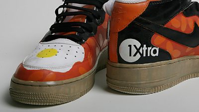 A colourful pair of trainers with a 1Xtra logo on the back. 