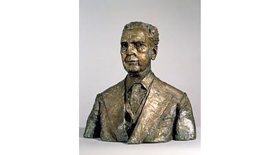 Bronze bust of William Haley in three piece suit.