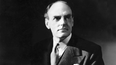 A striking black and white image of John Reith in a suit, looking wistfully into the middle distance.