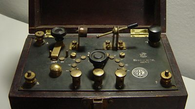 A box with many dials and switches. A small plaque with ý on is stuck on the top.