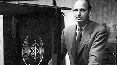 The BBC logo mechanical model next to its designer