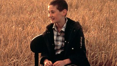 A boy in a field of wheat