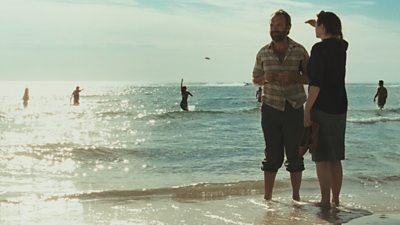 Hugo Weaving and Emily Watson on a beach