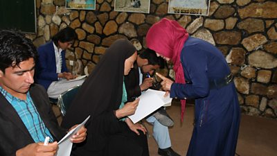 Seated participants at the radio station discussion