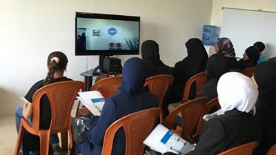 A group of women watch a BBC Media Action film in a Dawaween information centre in Lebanon