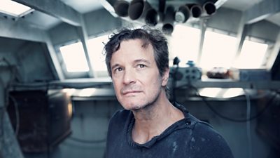 Colin Firth looks wistful in the cabin of a yacht 