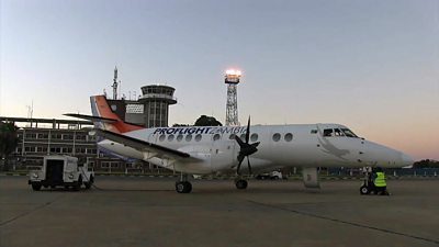 Turboprop airliner on tarmac at Lusaka airport