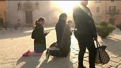 People praying in Norcia