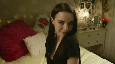 Girl in bedroom talking to webcam