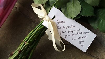 George Michael fans gather at his London home to pay tribute to the singer, who has died aged 53.