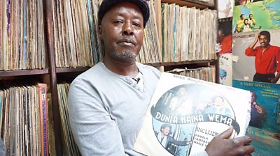 Stallholder holds vinyl record