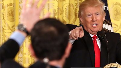 Donald Trump points at a journalist during a press conference