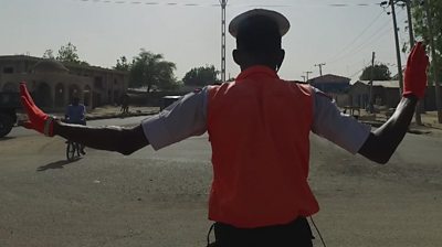 Traffic policeman with arms outstretched