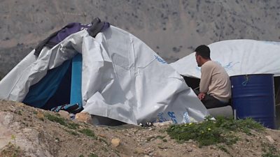 Man sitting near tent on Chios