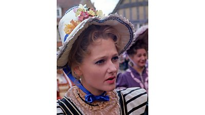 A close-up colour image of an actress in Regency costume.