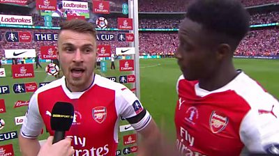 Arsenal players talk to a reporter