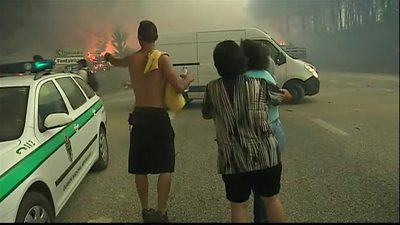 People watch as their homes get destroyed by fire