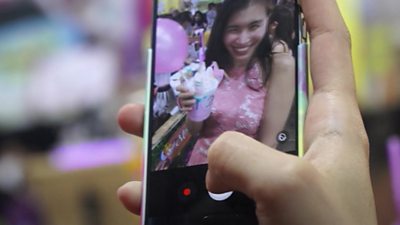 Person takes photo of girl drinking unicorn milkshake