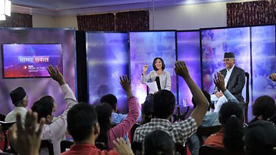 People raise hands as Bidhya Chapagain conducts the 500th episode of Sajha Sawal with Prime Minister, Sher Bahadur Deuba, at the prime minister's official residence.