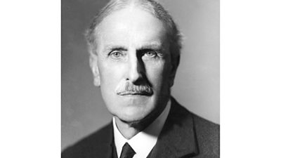 Black and white portrait of RC Norman. He has a neat trimmed moustache. 