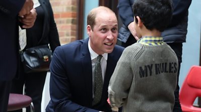 Duke of Cambridge speaks to a young boy