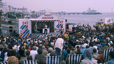 Crowds at on the beach at Eastbourne for a Radio 1 roadshow. The pier can be seen behind. 