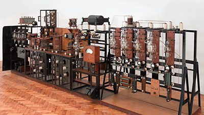 A large apparatus with many valves roughly the size of a regular room. 