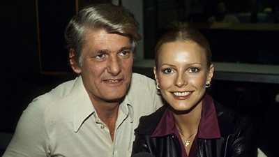 Cheryl Ladd smiles at the camera. Pete Murray seems to be distracted by another photographer