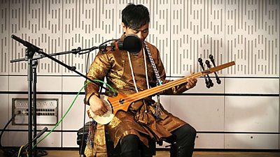 A world music performer in traditional dress in the studio