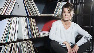 Verity Sharp sits on the floor of a record library