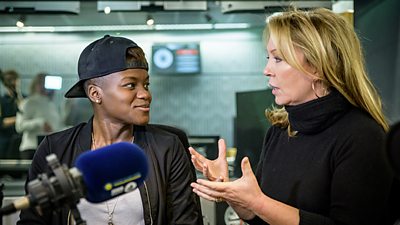 Kirsty Young talks to Nicola Adams. Nicola wears a back to front baseball cap