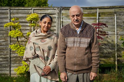 Sathnam's Mother (DEEPTI NAVAL), Sathnam's Father (ANUPAM KHER) Image Credit: BBC/Parti Productions & Kudos