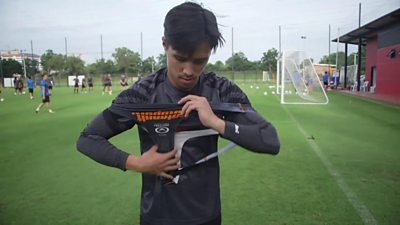 A player puts on a tracker